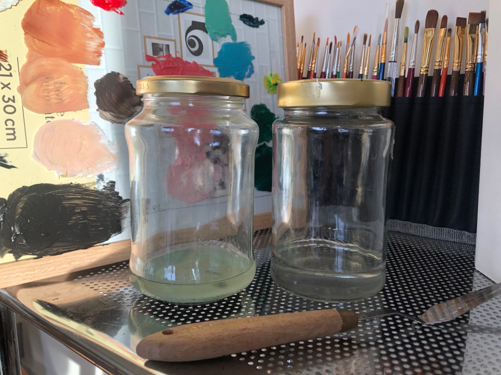 Oil painting clean up supplies, reused glass jars holding odorless mineral spirit
