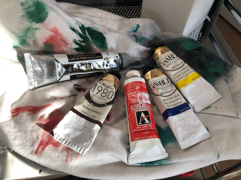 Collection of oil paints, a basic set up of colors including: titanium white, burnt umber, cadmium red, ultramarine blue, cadmium yellow. Primary colors.